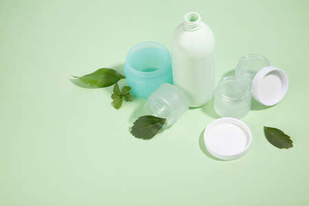 protect earth and environment concept, plastic containers and leavesの写真素材
