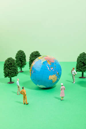 protect earth and environment concept, globe and people, wood miniatureの写真素材