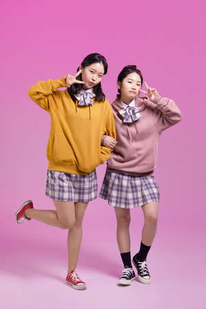 cute Korean Asian girls with v finger cheese poseの写真素材