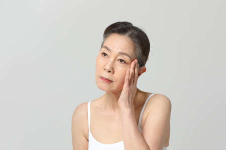 Asian Korean senior woman, basic skin care beauty concept in studioの写真素材