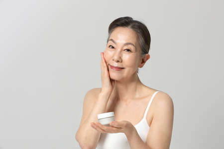 Asian Korean senior woman, basic skin care beauty concept in studioの写真素材