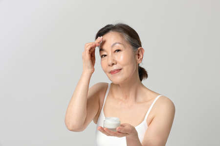Asian Korean senior woman, basic skin care beauty concept in studioの写真素材