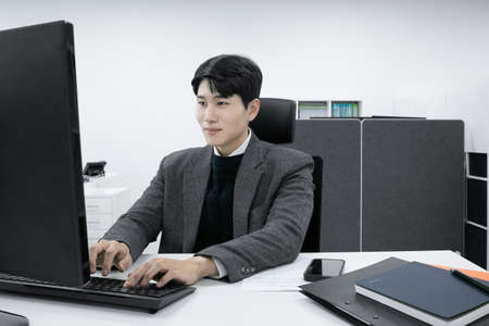 business concept asian korean old and young two men, different generations male man boss and employee concept, workingの写真素材