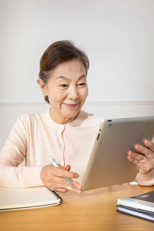 Asian Korean senior woman studying