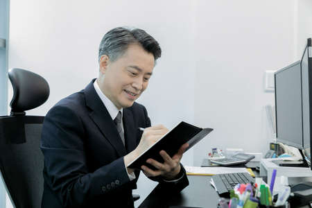 business concept asian korean man taking notesの写真素材