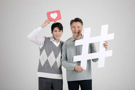 asian korean old and young two men holding frameの写真素材
