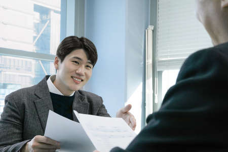 business concept asian korean old and young two men, different generations male man boss and employee concept, talking, having a meeting on document, projectの写真素材