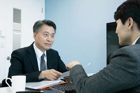 business concept asian korean old and young two men, different generations male man boss and employee concept, meetingの写真素材