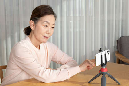 Asian Korean senior woman beauty creator, influencer, vlogger concept