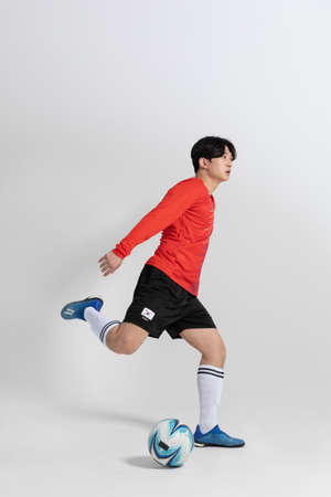 soccer football sports player, asian korean man with motions in studio backgroundの写真素材