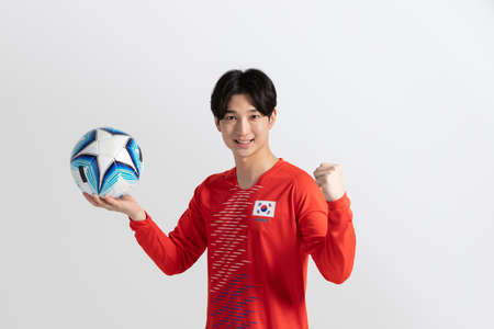 soccer football sports player, asian korean man with motions in studio backgroundの写真素材