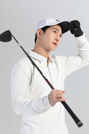 golf sports player, asian korean man with golf club in studioの写真素材