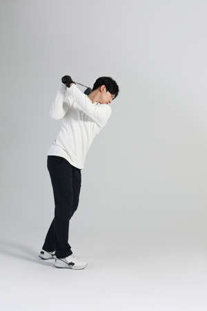 golf sports player, asian korean man with golf club in studioの写真素材