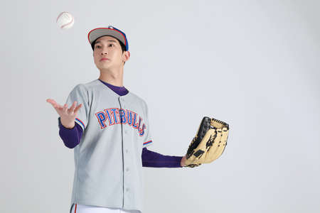 baseball sports player, asian korean man throwing and receiving ballの写真素材