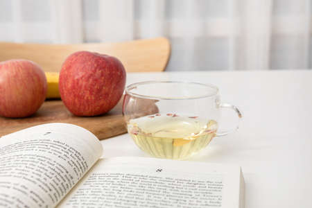 relax cozy objects and background with a book, tea, fruitsの写真素材