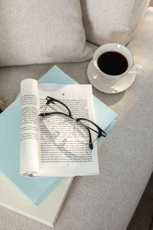 relax cozy objects and background with sofa,cushion, a book, glassesの写真素材