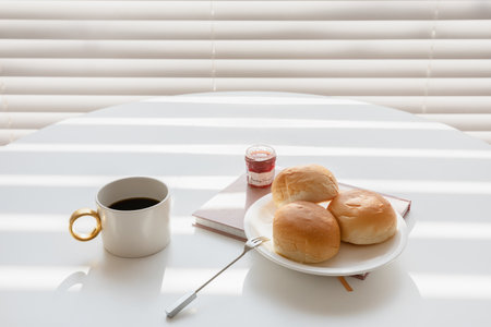 relax cozy objects and background with bread, coffee, candle, a bookの写真素材