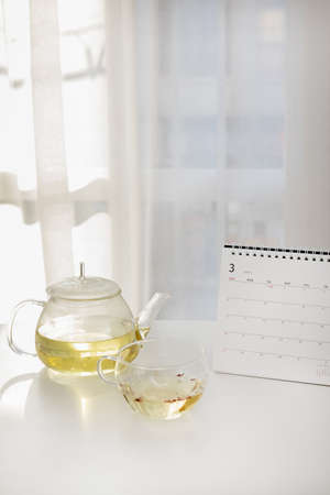 relax cozy objects and background with tea and calendar, curtainsの写真素材