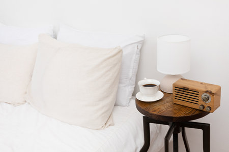 relax cozy objects and background with bedding, lights, coffee, a book, radio