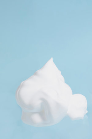 isolated smear beauty cosmetics texture of cleansing foam bubble in blue background
