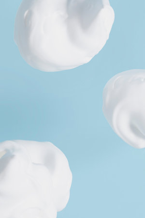 isolated smear beauty cosmetics texture of cleansing foam bubble in blue backgroundの写真素材