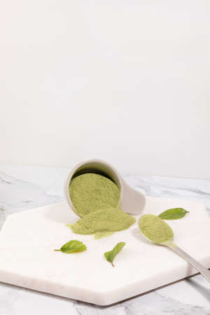 matcha green tea powder powder in a white bowlの写真素材