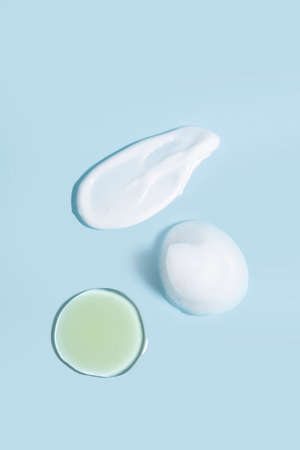 isolated smear beauty cosmetics texture of cleansing balm, cleansing oil, cleansing milk in blue...