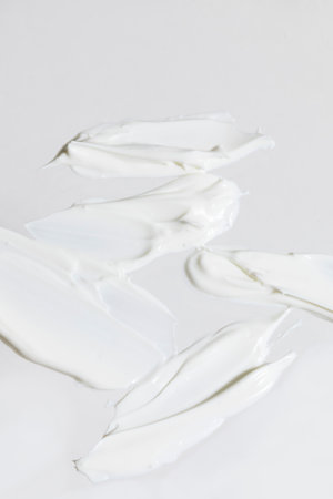 isolated smear beauty cosmetics texture of face cream, white backgroundの写真素材