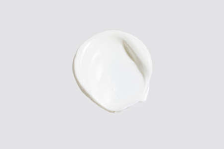 isolated smear beauty cosmetics texture of face cream, white background