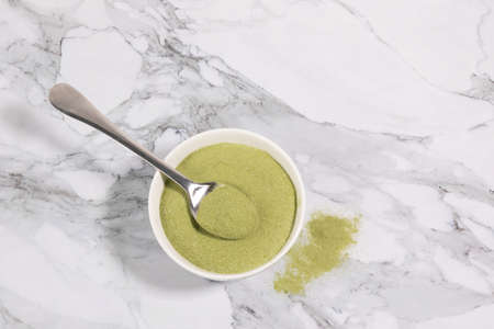 matcha green tea powder powder in a white bowlの写真素材