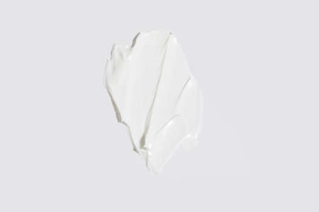 isolated smear beauty cosmetics texture of face cream, white backgroundの写真素材
