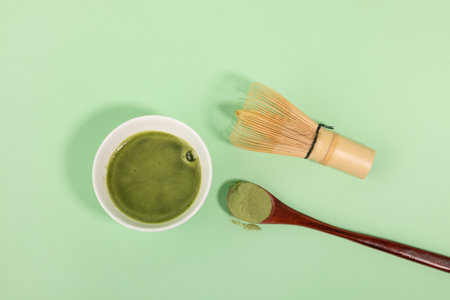 matcha green tea powder and drink in green backgroundの写真素材