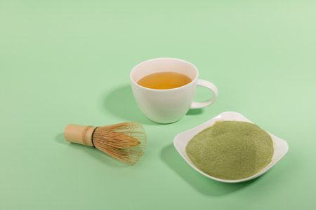 matcha green tea powder and drink in green background