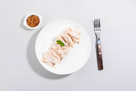 boiled chicken breast on a plate, white backgroundの写真素材