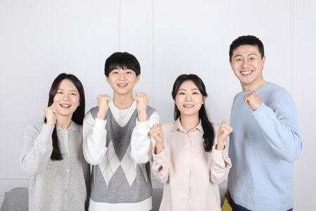 Asian Korean family_Family photo in a cheer up poseの写真素材
