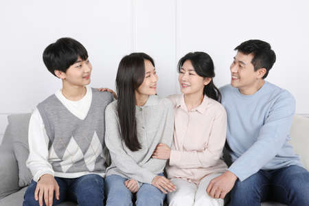 Asian Korean family_Photo of a smiling family facing each otherの写真素材