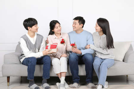 Asian Korean Family_celebration of parents day with carnations and giftsの写真素材