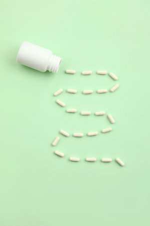 creative concept of medical pills on a green background