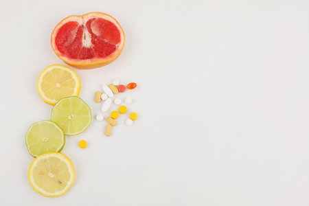 fruits and pills, white background, medical creative concept photoの写真素材