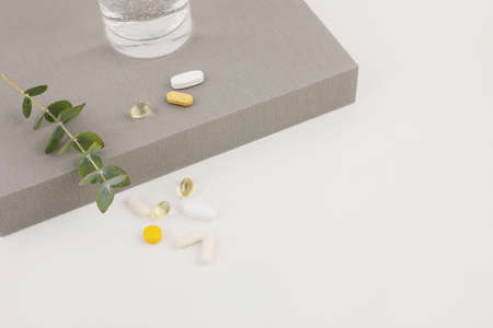 water and pills, white background, medical creative concept photoの写真素材