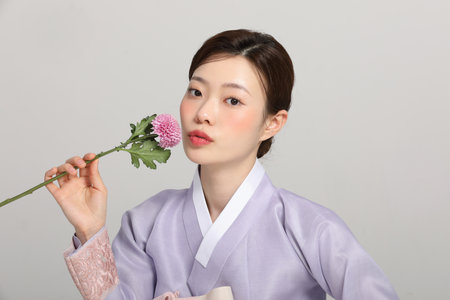 spring beauty concept, beautiful korean woman wearing hanbok with flowersの写真素材