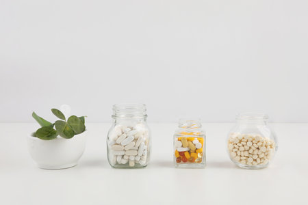 plants and pills, white background, medical creative concept photoの写真素材