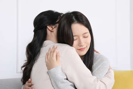 Asian Korean family_Mother and daughter comforting each otherの写真素材