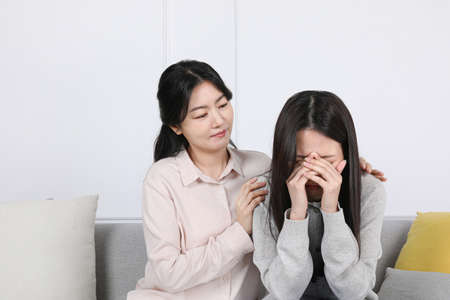 Asian Korean family_ mother comforting daughter photo
