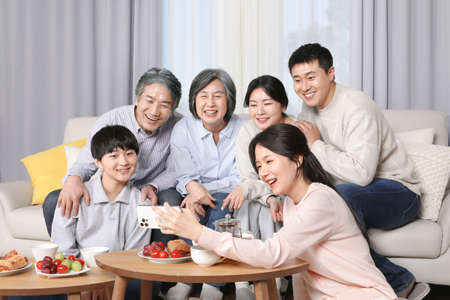 Asian Korean Family_Watching video on cell phoneの写真素材