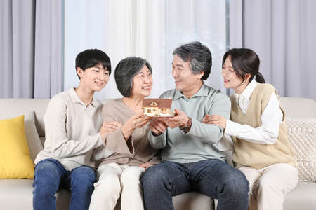 Asian Korean family_House model held by grandparents and grandchildrenの写真素材