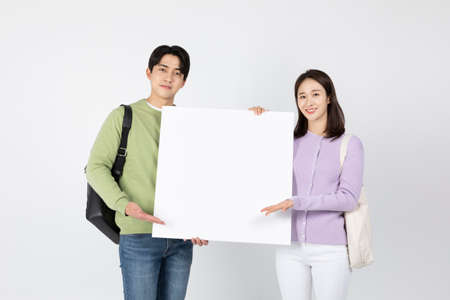 job interview_ asian korean young woman and man holding a panelの写真素材