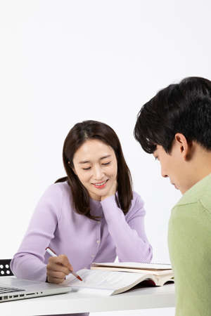 job interview preparation_ asian korean young woman and man, teach each other to studyの写真素材