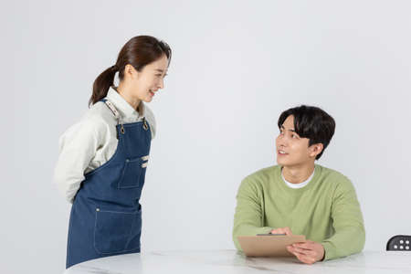 Asian Korean young man and woman startup concept_customer and boss orderingの写真素材