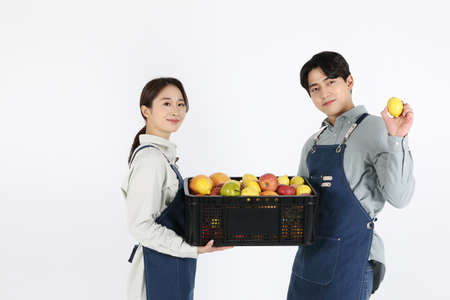 Asian Korean young man and woman startup concept_ carrying luggage togetherの写真素材